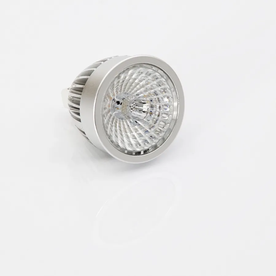 A reflector-style LED light bulb on a white surface